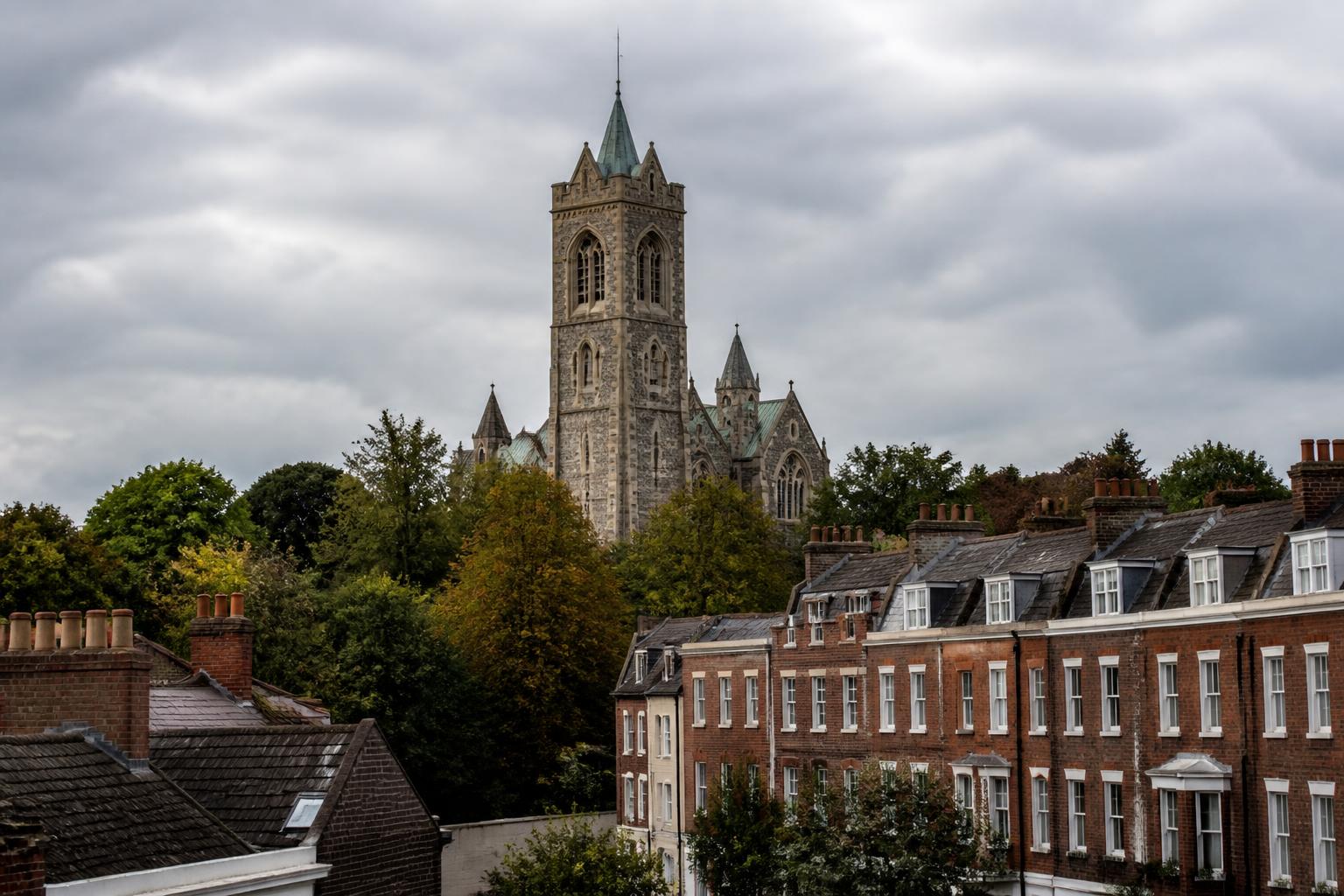 The stone tower of Chelmsford Cathedral rising above red-brick Georgian rooftops, Essex