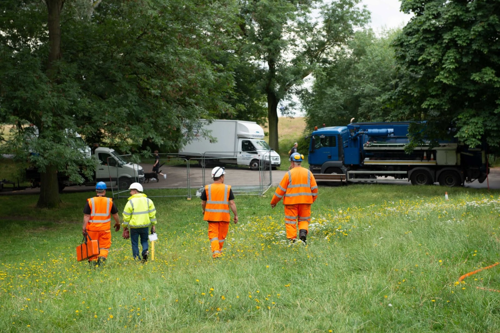 Drainage team walking to site with jetting tanker on a commercial project